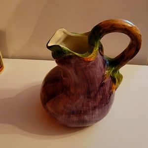A pitcher made to resemble a Majolica egg.  Color is purple, made in Italy.